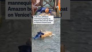 A life-size Jeff Bezos mannequin gripping an Amazon box was set afloat on Venice's Grand Canal