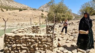 nomadic mother and son fight to survive in the mountains by building a stone house beside the river