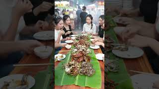 Elegant Chinese women feast on traditional street food.@FlavorHunts-ai