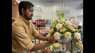 Plastic flower bouquet in glass