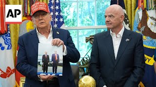 Trump holds up a photo Putin sent him: 'I'm going to sign this for him'