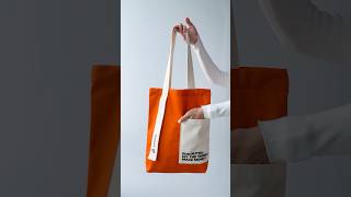 🌟👜 Stand Out: Orange Bag with Unique Printed Pocket #OrangeStyle #FashionBag #PrintDetails