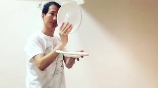 Man Balances Spinning Plate on Top Another Plate - 1008747-2