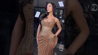 Share with a friend who would own the spotlight in this golden draped slit gown! To order, send us a