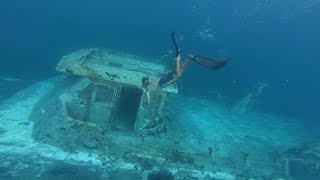 Divers Explore Sunken Ship Wreck