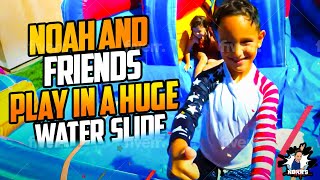 Noah and friends play in a Huge Water Slide, lots of fun