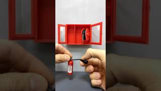 Miniature fire cabinet. Fire extinguisher and fire hose. 3d printing
